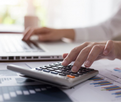 Picture of accountant using laptop and calculator