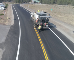 installation of pavement markings occurring on Rosland Rd.