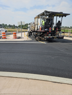 Crews installing permanent pavement markings at Powell Butte Hwy and Butler Market Road, August 2024