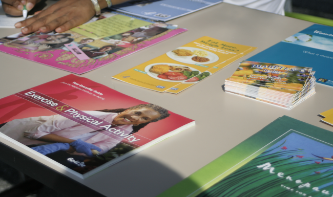 Brochures on a table at a Public Health event.