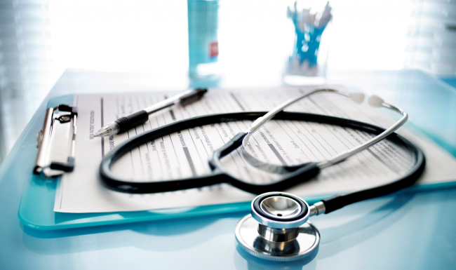 Stethoscope and clipboard on a table