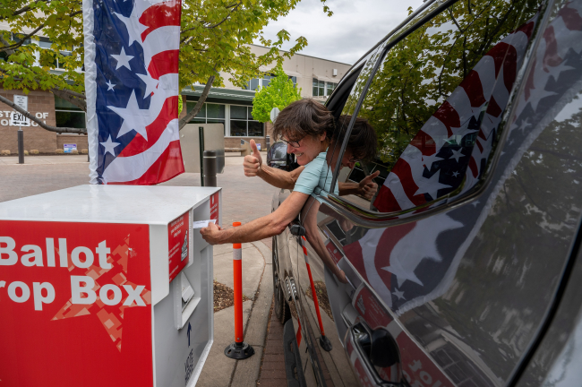 Image of a driver using a ballot drop box