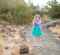 Little girl on dirt path facing camera photo